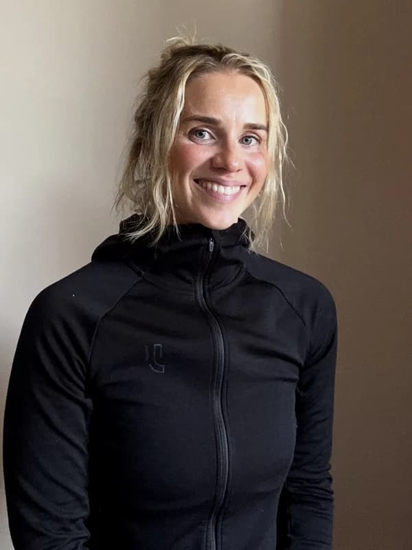 Ingse Bergh Bjelland smiling, in a black training jacket against a plain wall